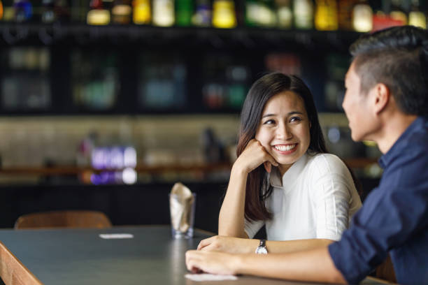 istock Young Asian Couple At A Bar 957624426