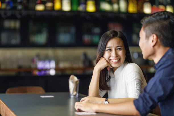 istock Young Asian Couple At A Bar 957624434