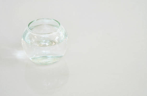 Closeup glass cup with water on gray marble stone floor background