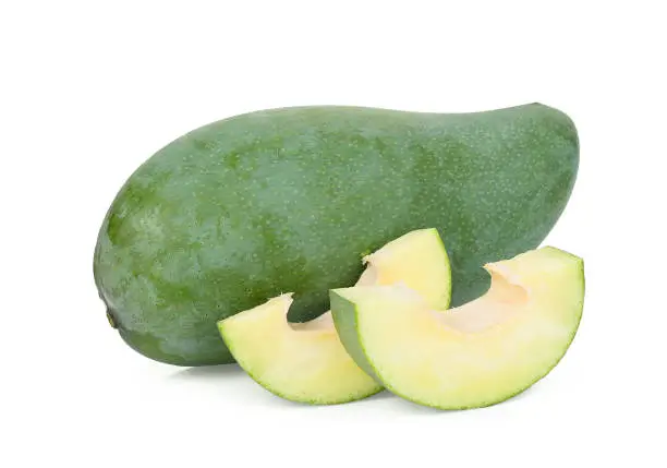 Photo of whole and slice green mango isolated on white background