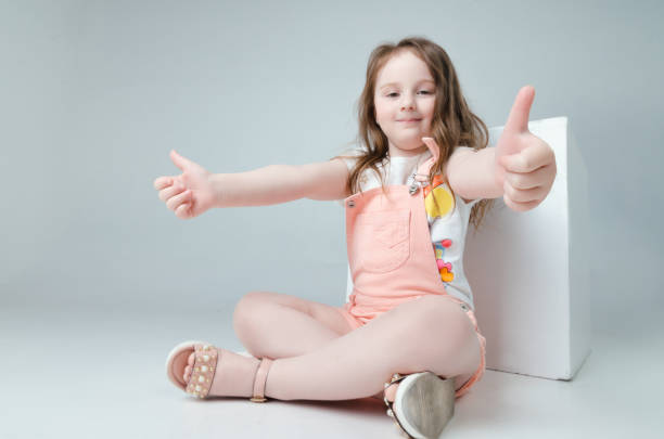 istock child in the Studio posing in fashionable clothes 957632568