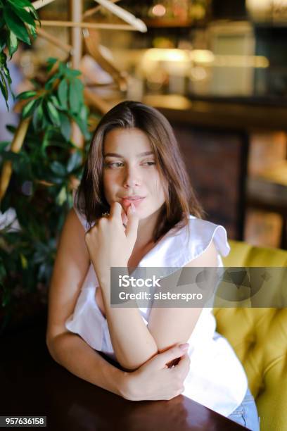 Businesswoman Sitting At Cafe At Table Near Green Plant Stock Photo - Download Image Now