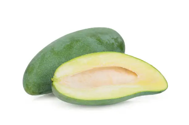 Photo of whole and half green mango isolated on white background