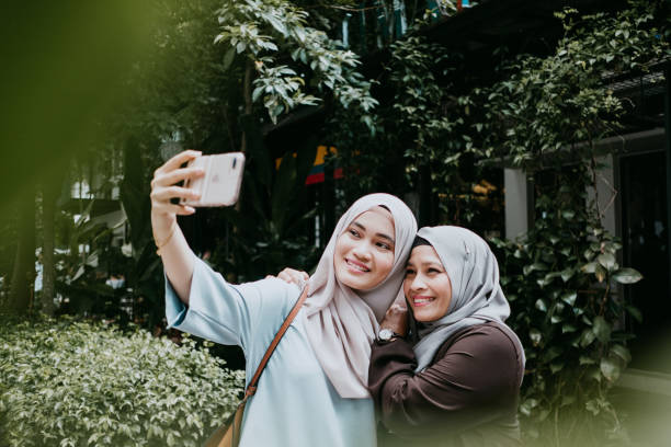 istock mom and daughter taking selfie 957638080
