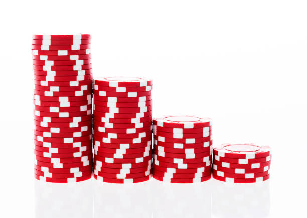 istock Stacks of red poker chips in a row 957638576