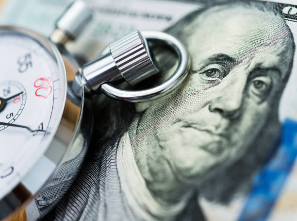 istock American dollar and stop watch 957641612