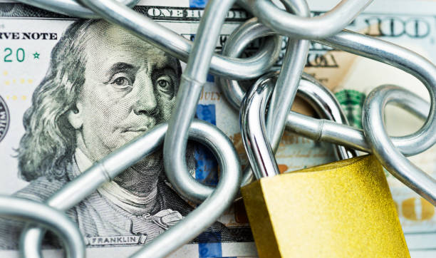 istock One hundred dollar bill with a chain and lock 957642064