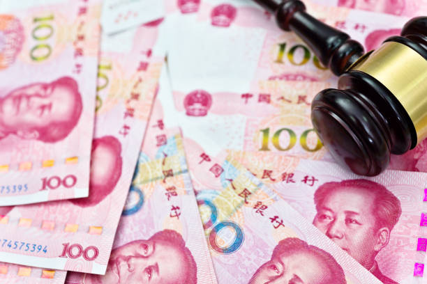 istock Group of Chinese yuan note and gavel 957642498