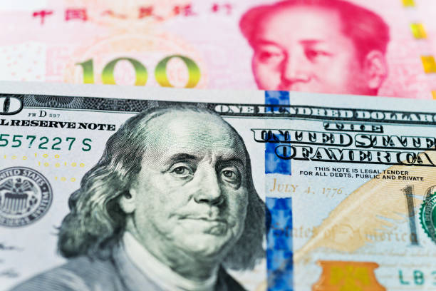 istock US dollars and Chinese yuan background 957642558