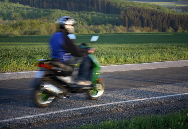 Teen riding home on his moped, motion blur  moped stock pictures, royalty-free photos & images