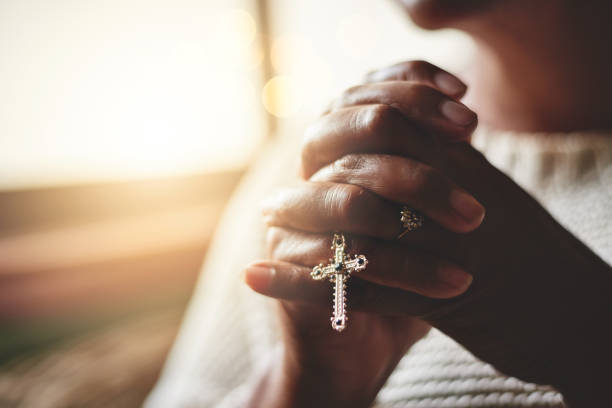 Prayer is the pillar of strength Closeup shot of an unrecognizable woman holding a rosary while praying christianity stock pictures, royalty-free photos & images