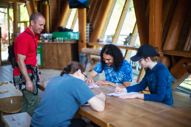 istock Young people signing waiver documents at an adventure park 957653982