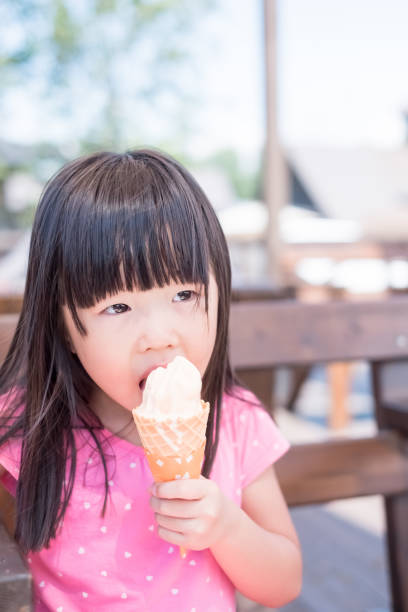 istock cute girl eat ice cream 957654230