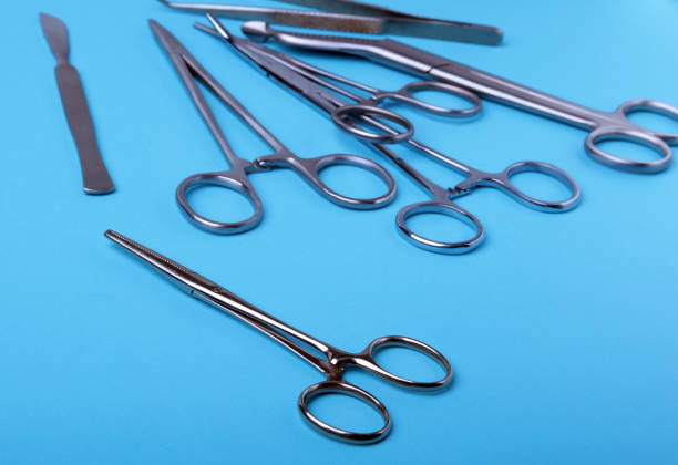 istock surgical instruments and tools including scalpels, forceps and tweezers arranged on a table for a surgery. 957654716