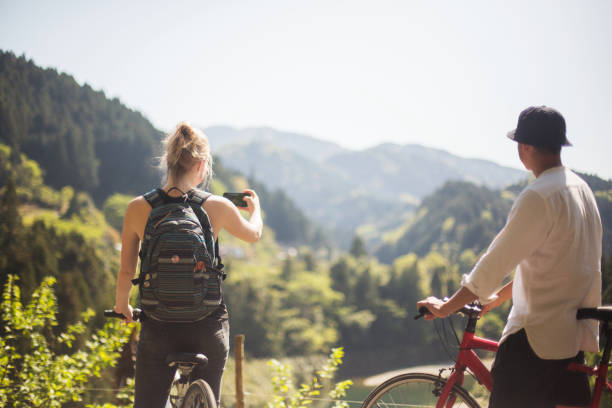 istock Young couple enjoying a view while cycling in the mountains 957655286