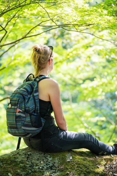 istock Woman taking a rest while hiking in the mountains 957655980