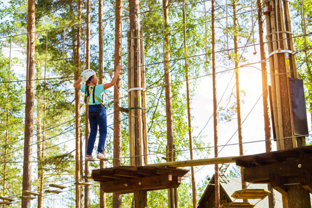 istock Girl on hinged trail in extreme rope Park 957669134