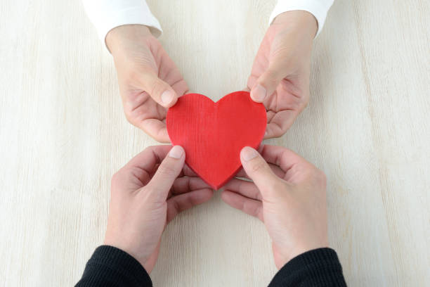 istock Heart had by man and woman's hand 957669154