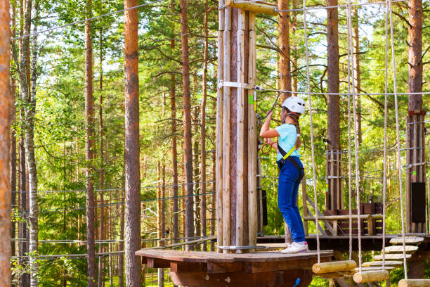 istock Girl on hinged trail in extreme rope Park 957669174