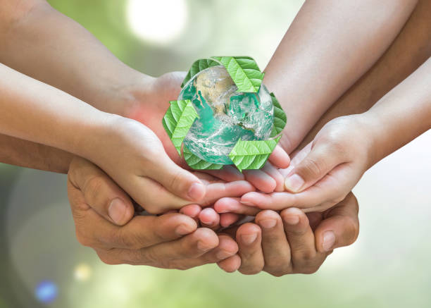 Parent guardian children hands holding together recycled green leaf arrow sign planet on blur nature greenery background sun flare Environment CSR ESG concept Element of this image furnished by NASA Parent guardian children hands holding together recycled green leaf arrow sign planet on blur nature greenery background sun flare Environment CSR ESG concept Element of this image furnished by NASA biodegradable photos stock pictures, royalty-free photos & images