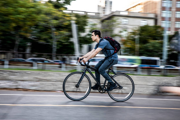 istock Young man cycling in the city, commuting to work 957669250