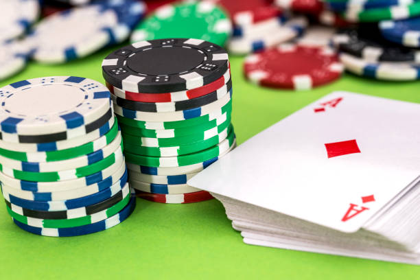 istock concept - poker chips, playing cards close 957669268