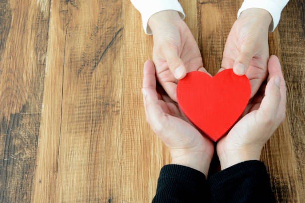 istock Heart had by man and woman's hand 957669272