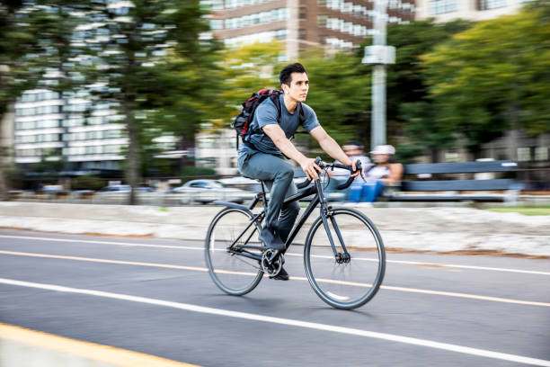 istock Young man cycling in the city, commuting to work 957669294
