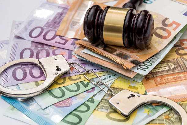 istock Justice, bribery and punishment. Euro with handcuffs and gavel 957669318