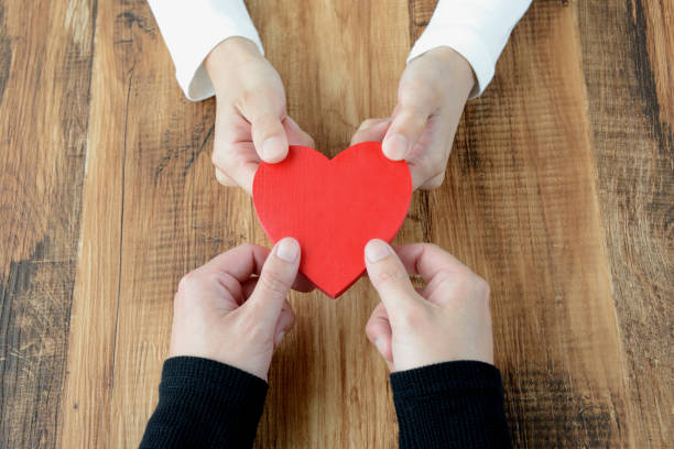 istock Heart had by man and woman's hand 957669340