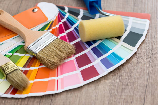 paint brushes on colour swatch, wooden table background - color swatch print color image spectrum imagens e fotografias de stock