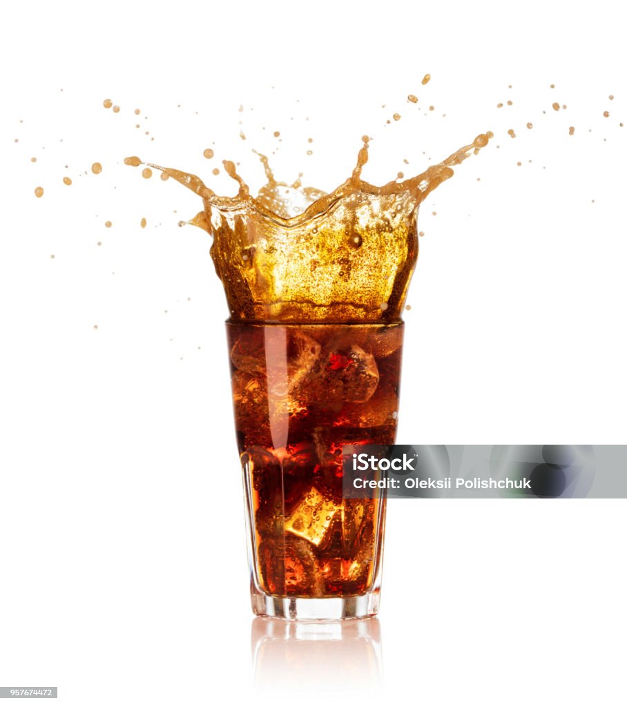 glass of cola with splash isolated glass of ice and cola with big splash isolated on white background Cola Stock Photo