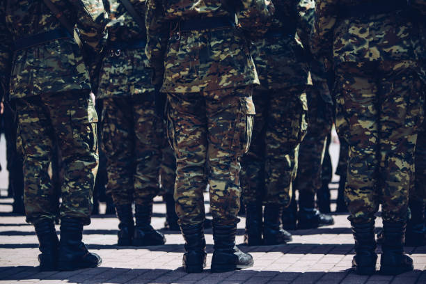 istock Soldiers in masking camouflage uniforms on parade 957676530