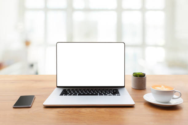 istock laptop showing blank screen with cup of coffee and mobile phone on table 957676598