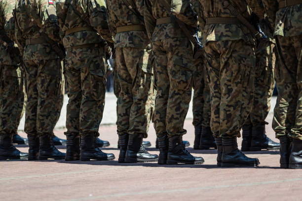 istock Soldiers in masking camouflage uniforms on parade 957676856
