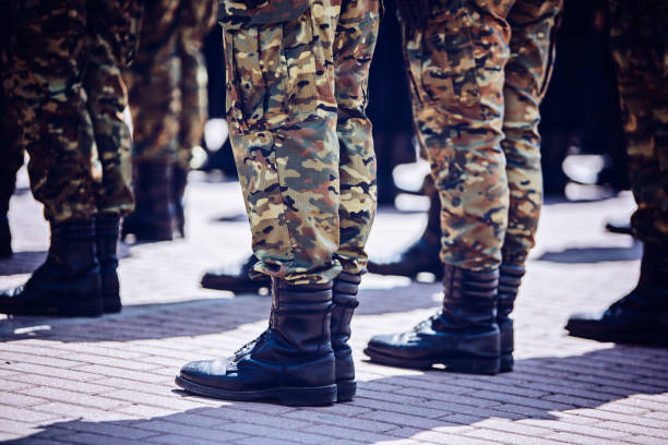 istock Soldiers in masking camouflage uniforms on parade 957677040