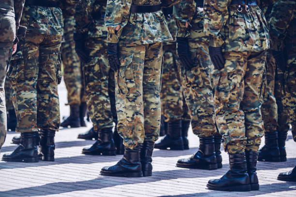 istock Soldiers in masking camouflage uniforms on parade 957681392