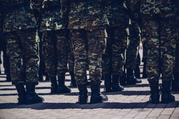 istock Soldiers in masking camouflage uniforms on parade 957684382
