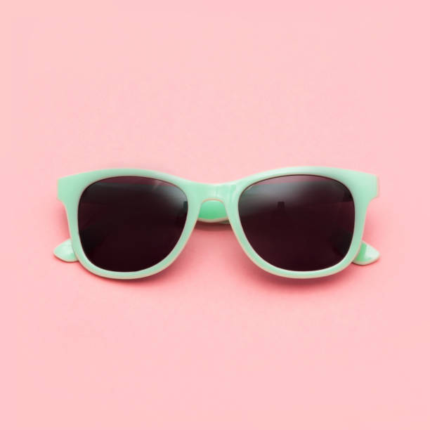 istock Mint sunglasses isolated on pink background. Closeup. 957685056