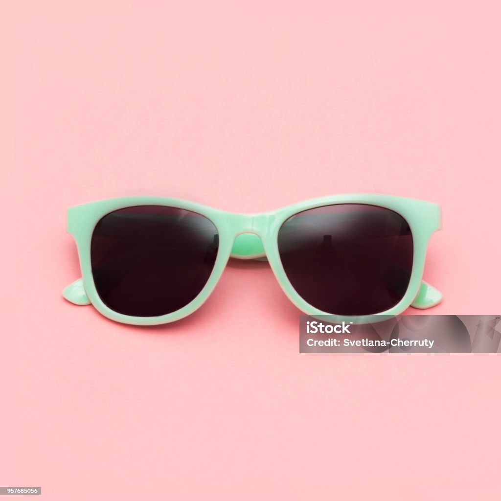 Mint sunglasses isolated on pink background. Closeup. Mint sunglasses isolated on pink background. Closeup. Square image. Sunglasses Stock Photo