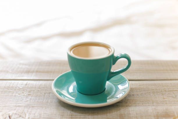 istock Hot coffee latte isolated on wooden table 957685108