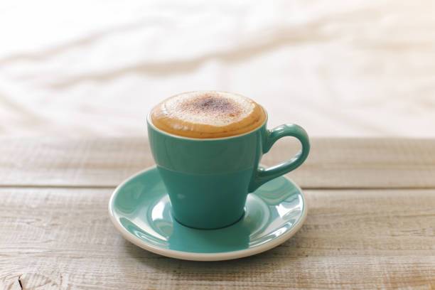 istock Hot coffee cappuccino isolated on wooden table 957685174