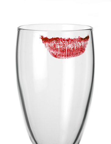 empty glass with lipstick kiss print isolated on white background