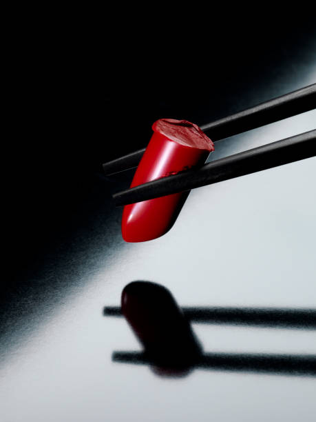 elegant red lipstick as sushi between chopsticks