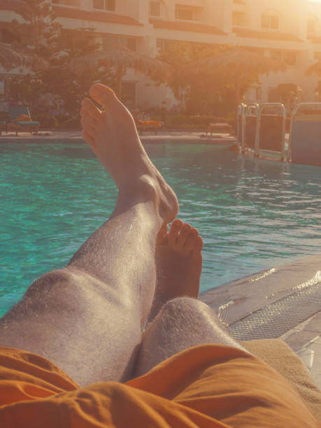 istock Man enjoying at the swimming pool on a hot summer day. 957686332
