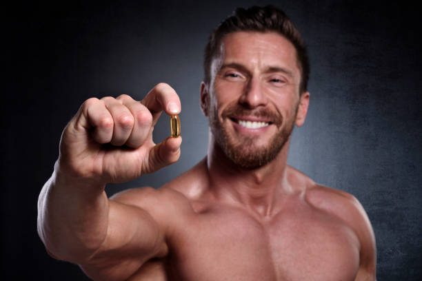 мужской фитнес-спортсмен - anti aging pill capsule vitamin pill стоковые фото и изображения