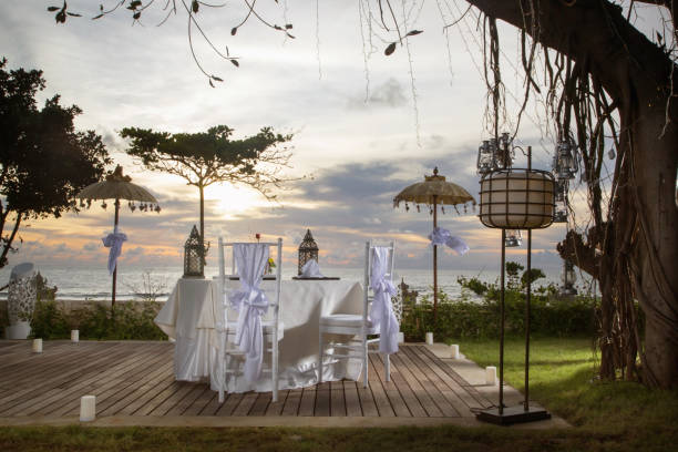 istock Beautiful romantic dinner set up, sunset time, tropical style 957689770