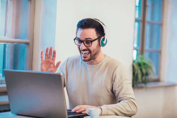istock Happy young man works on his laptop 957691200