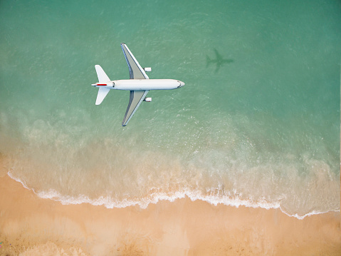 Airplane flying over the beach