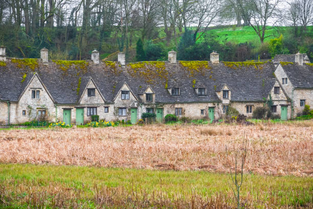 istock Cotswold stone cottages, Arlington Row, Bibury, Gloucestershire, England 957697946